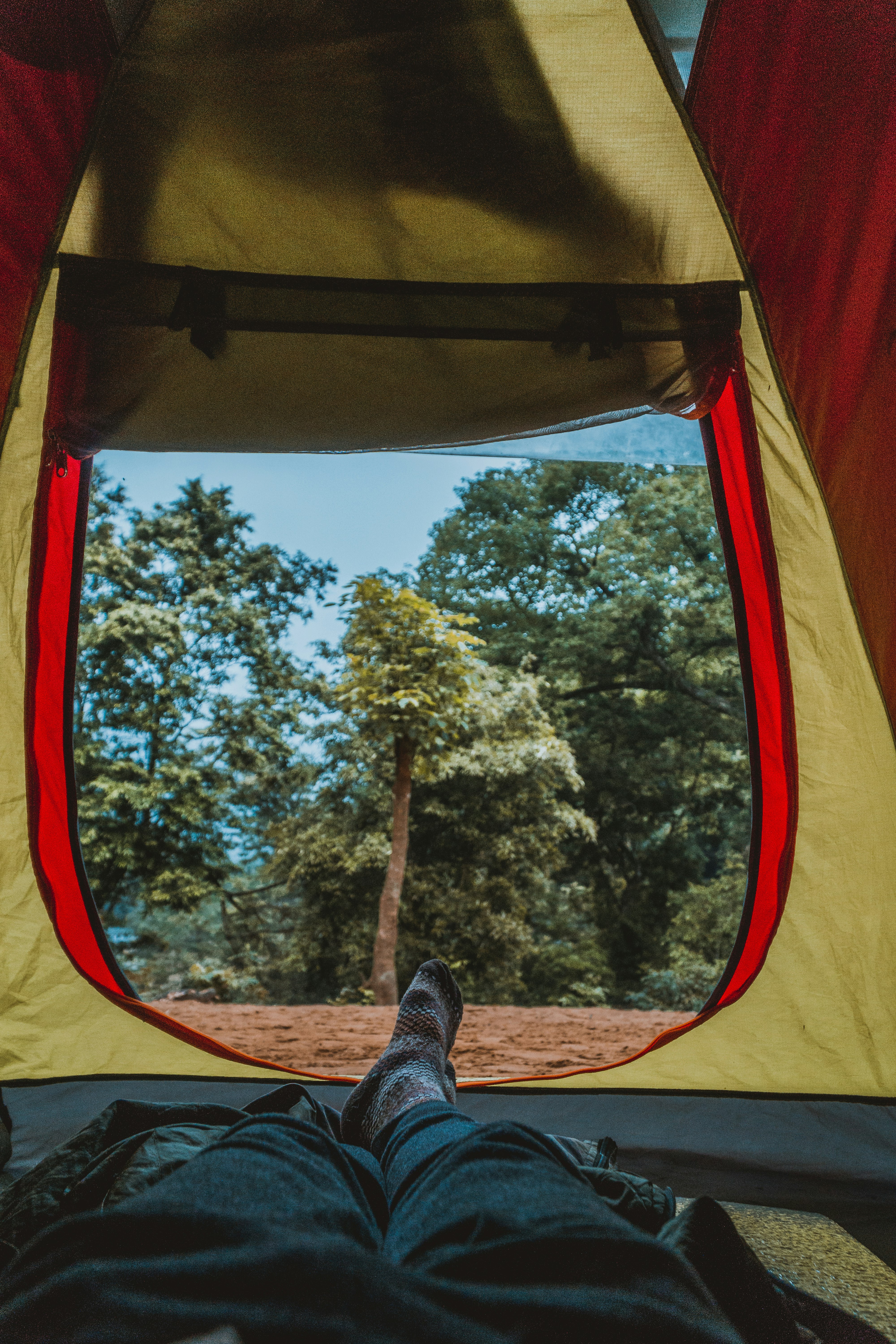 photo of man laying inside the tent